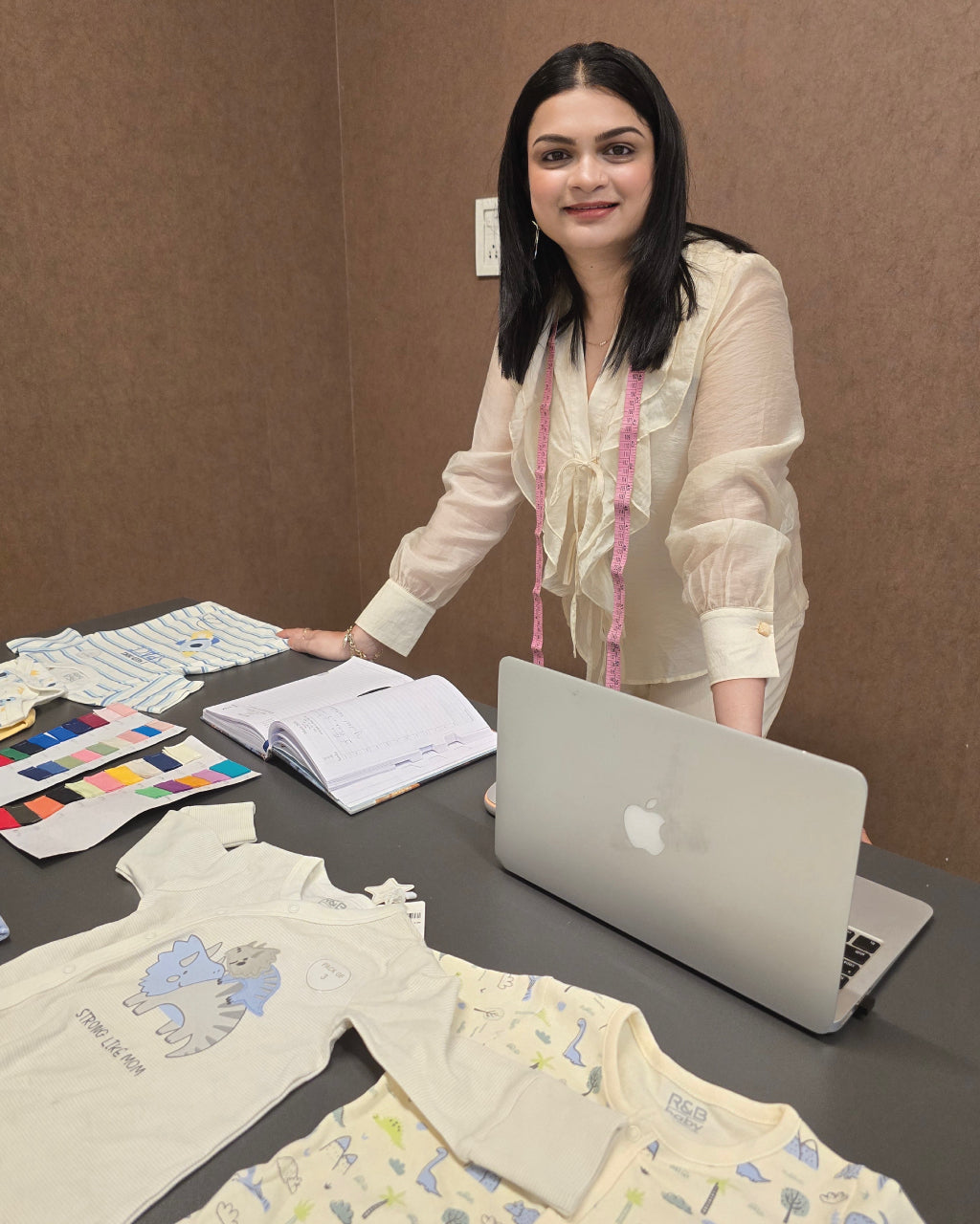 Founder Vishudha with fabric swatches and testing materials at her work desk